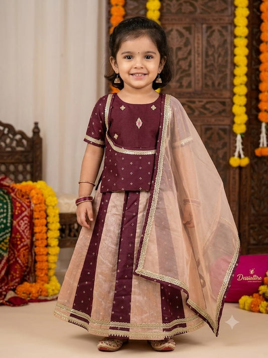 Girl wearing a maroon choli with a maroon and beige panelled lehenga and sheer beige dupatta with gold-tone trim